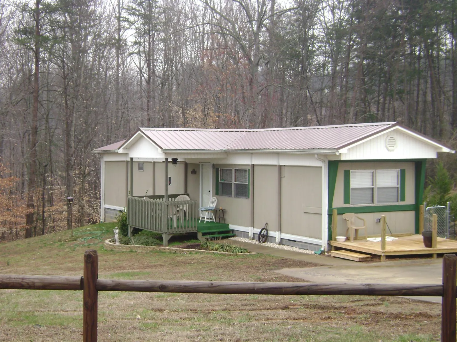 Mauve metal roof on a manufactured home with a new front deck in Tecumseh